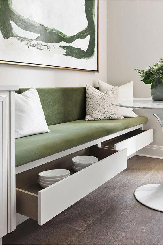 Built in banquette with storage drawers and a large piece of art above the bench