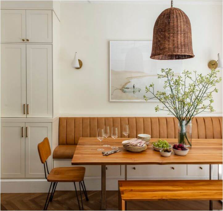 Leather upholstered custom built in bench with drawers with a rectangular wooden table in front of the bench