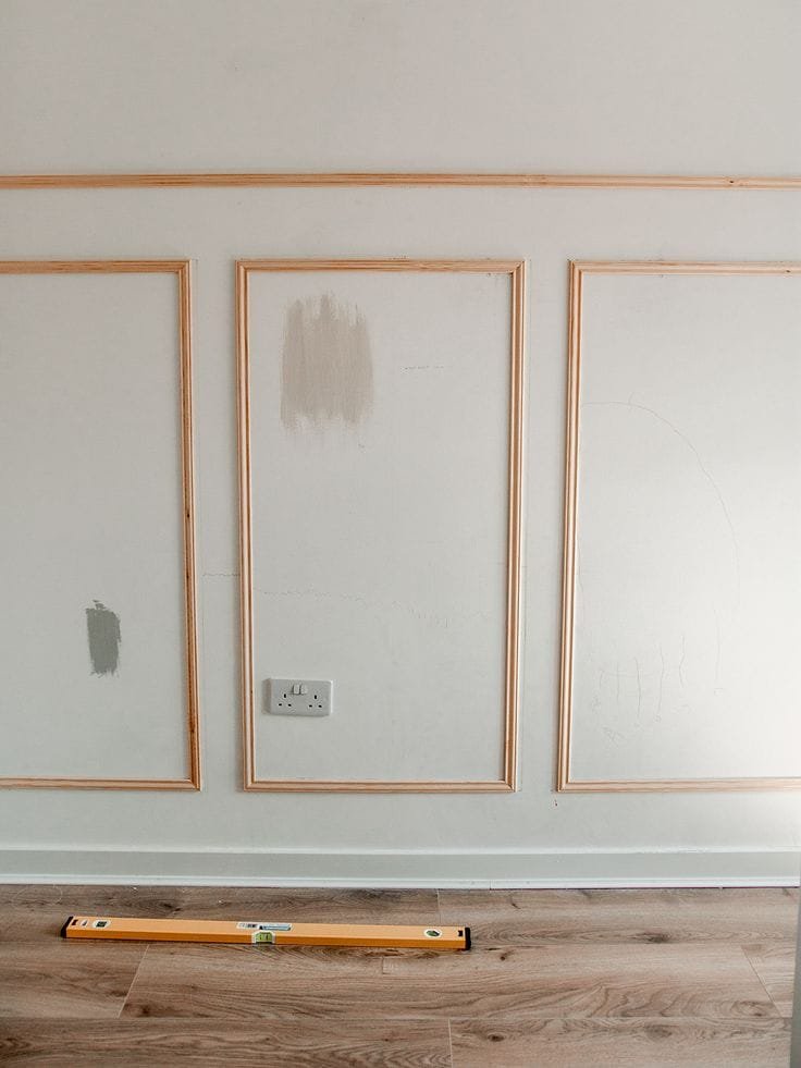 Inexpensive wall paneling idea showing how to place molding directly onto drywall