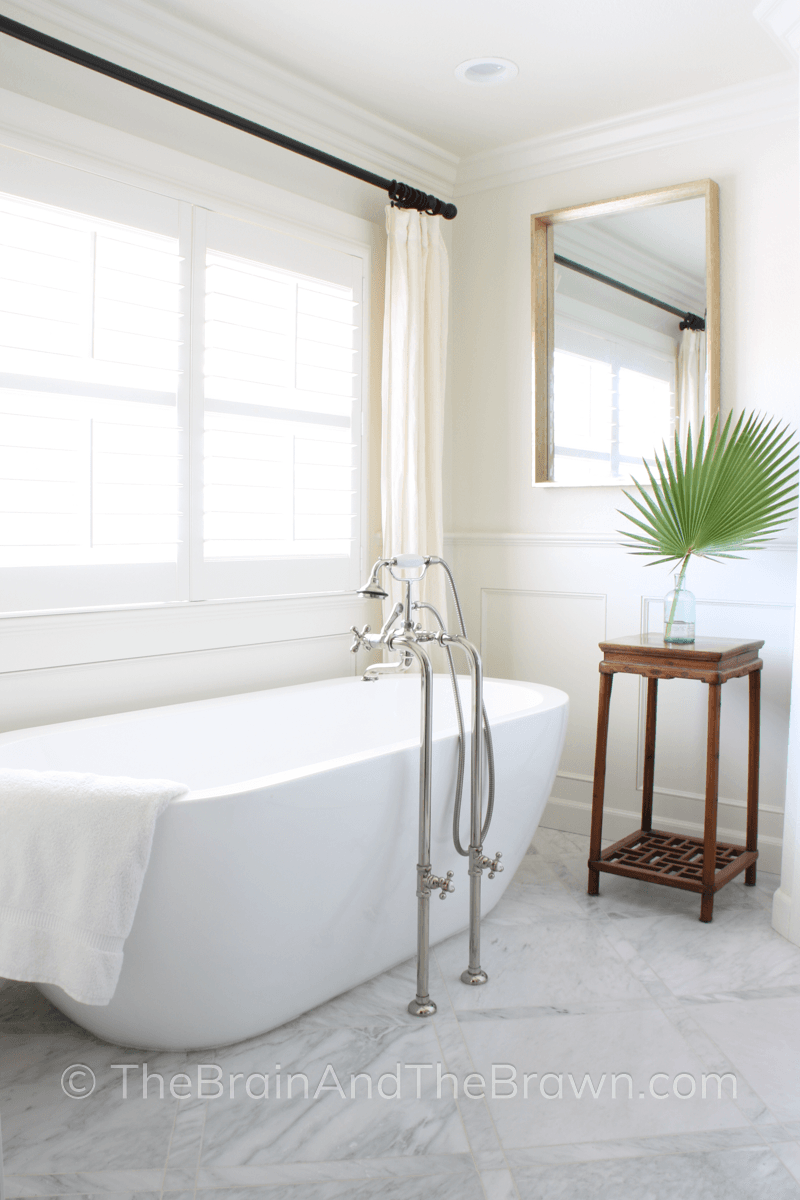 Luxurious master bathroom with a  half wall panelling idea painted the same color as the wall