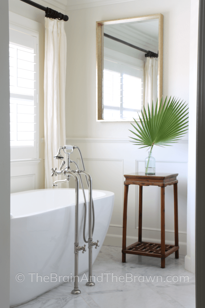 half wall wood paneling idea painted white in a bathroom with a floating tub 