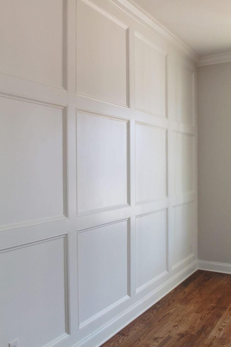 White wood panel accent wall in a grid pattern