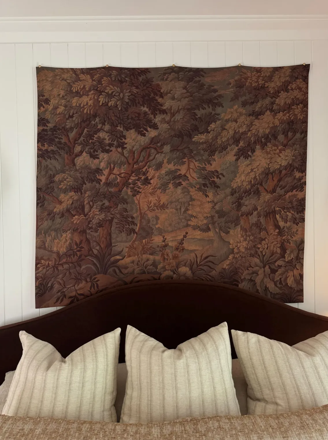 Vintage looking large tapestry hanging from wall is a unique bedroom wall art idea
