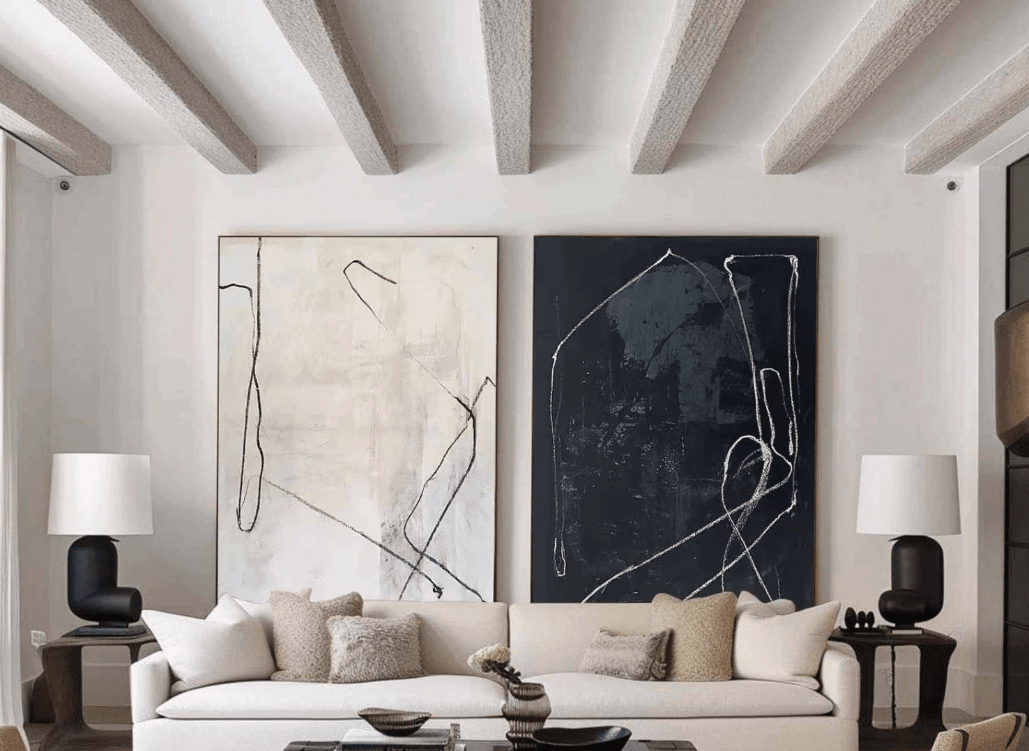 Wall art ideas for living room with two large pieces of abstract artwork as the focal point behind an off-white sofa