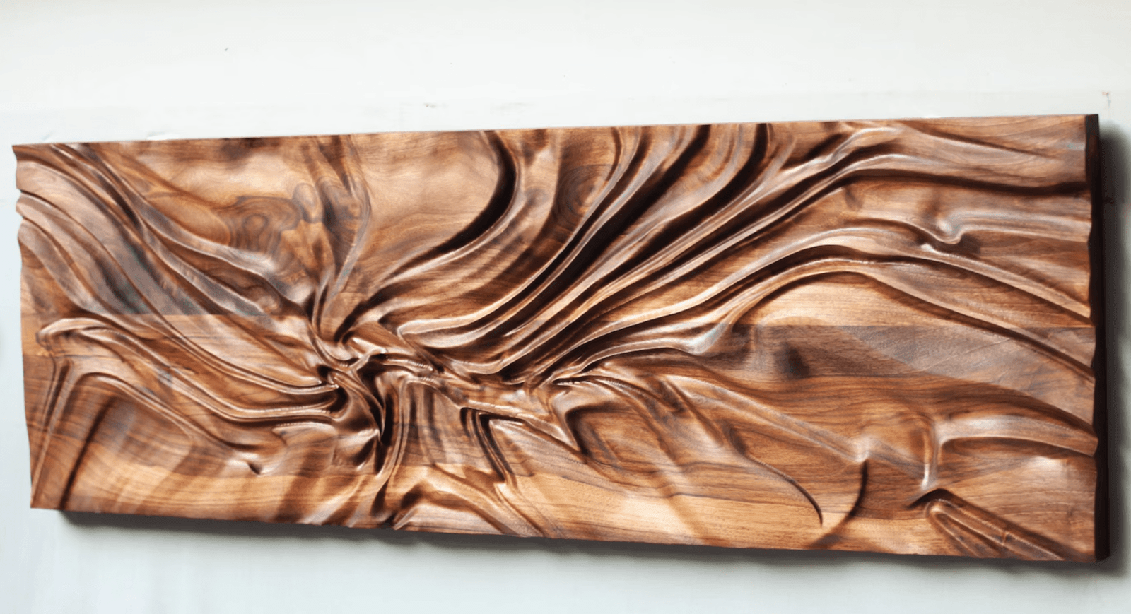 A carving made out of wood is a wood wall art idea