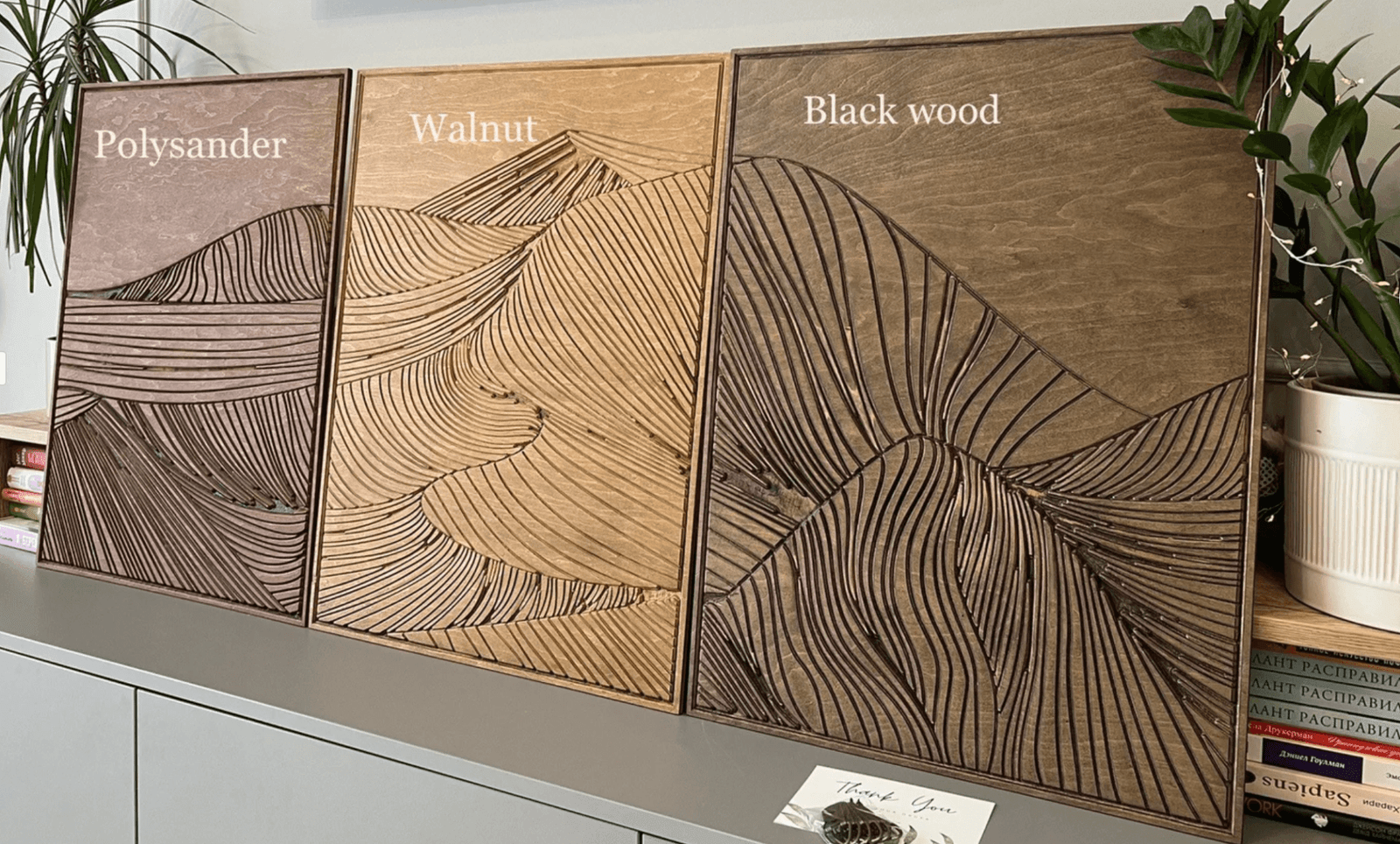 Three different types of wood with abstract drawing etched in it is a dining room wall art idea 