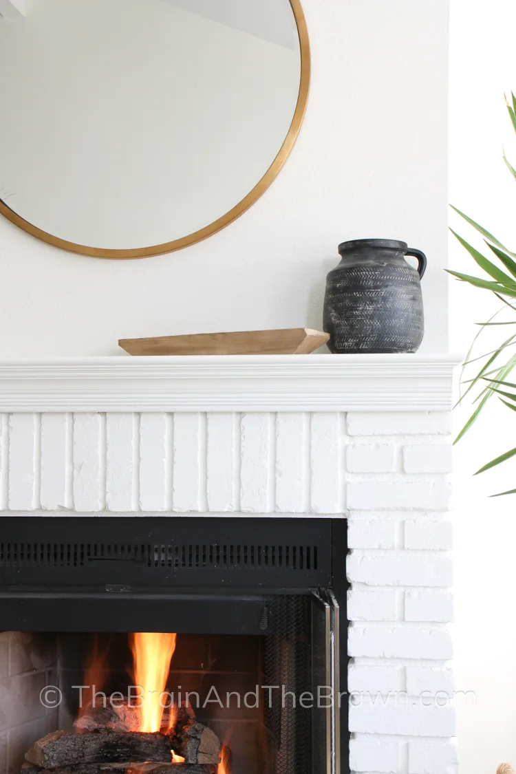 An "after" photo of a painted brick fireplace