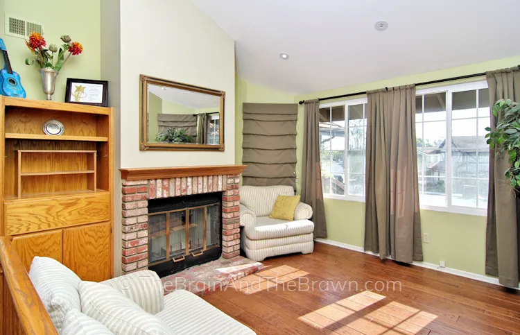A "before" photo of a brick fireplace wall idea in a master bedroom sitting area