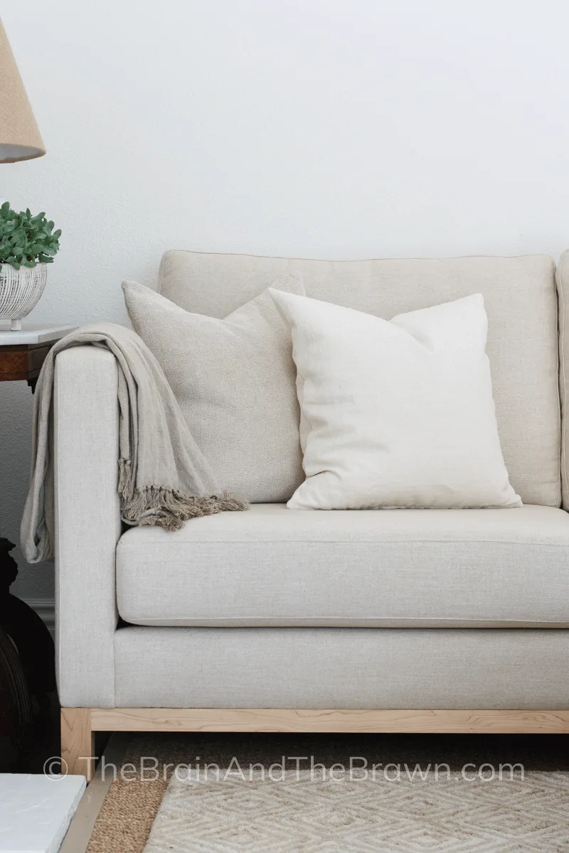 Cream colored custom sofa with neutral colored pillows in a living room