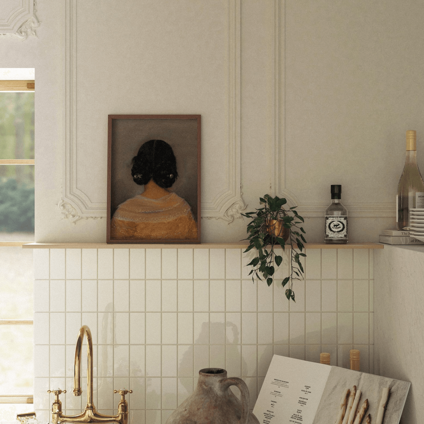 Artwork of the back of a woman's head is on a shelf in a kitchen