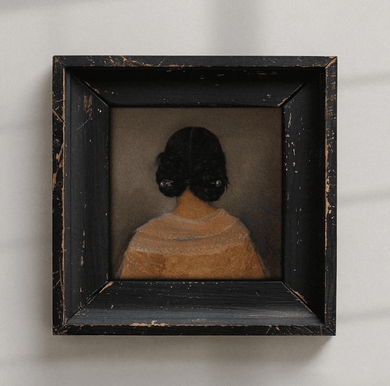 Artwork of the back of a woman's head in a vintage black frame