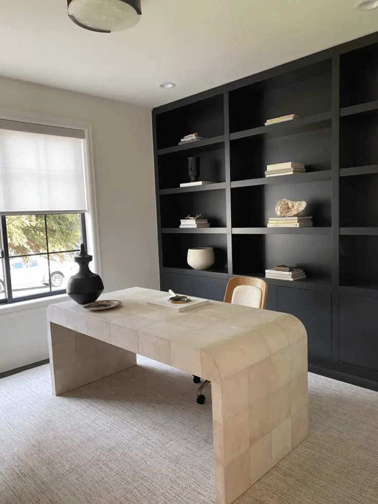 modern home office design idea with black bookshelves and unique desk curved