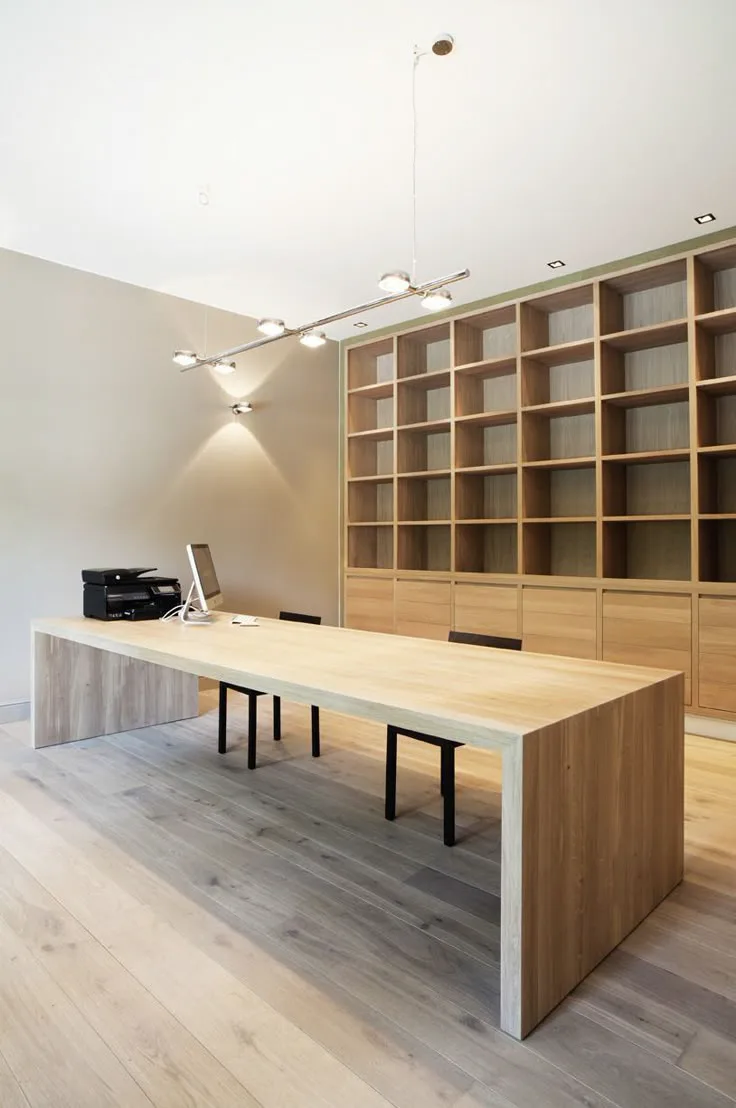 his and hers shared home office design with floor to ceiling bookshelves and storage in wood
