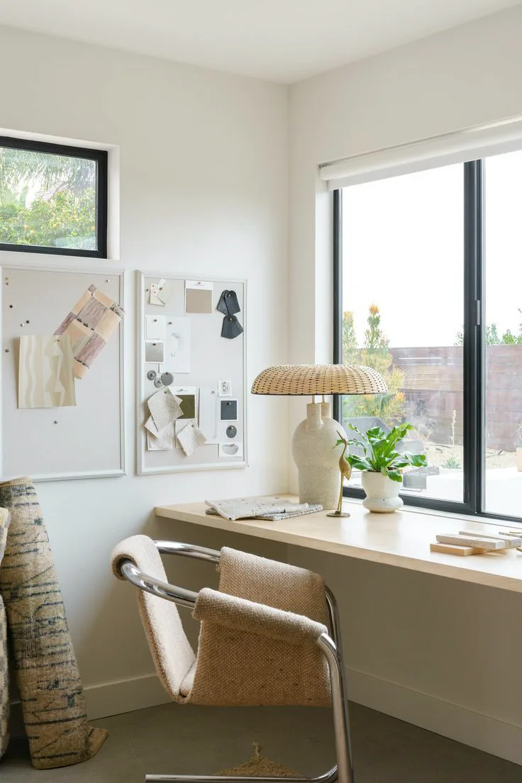 a thin floating wood desk in a small home office with a modern chair