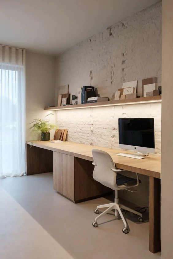 textured brick or stone wall painted white in home office