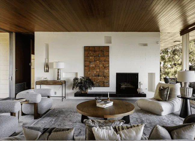 spanish-style home interior living room with off-centered fireplace