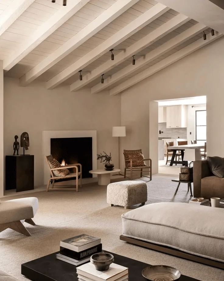 a large living room interior with white plank ceiling and fireplace, modern furniture and decor in neutral colors 