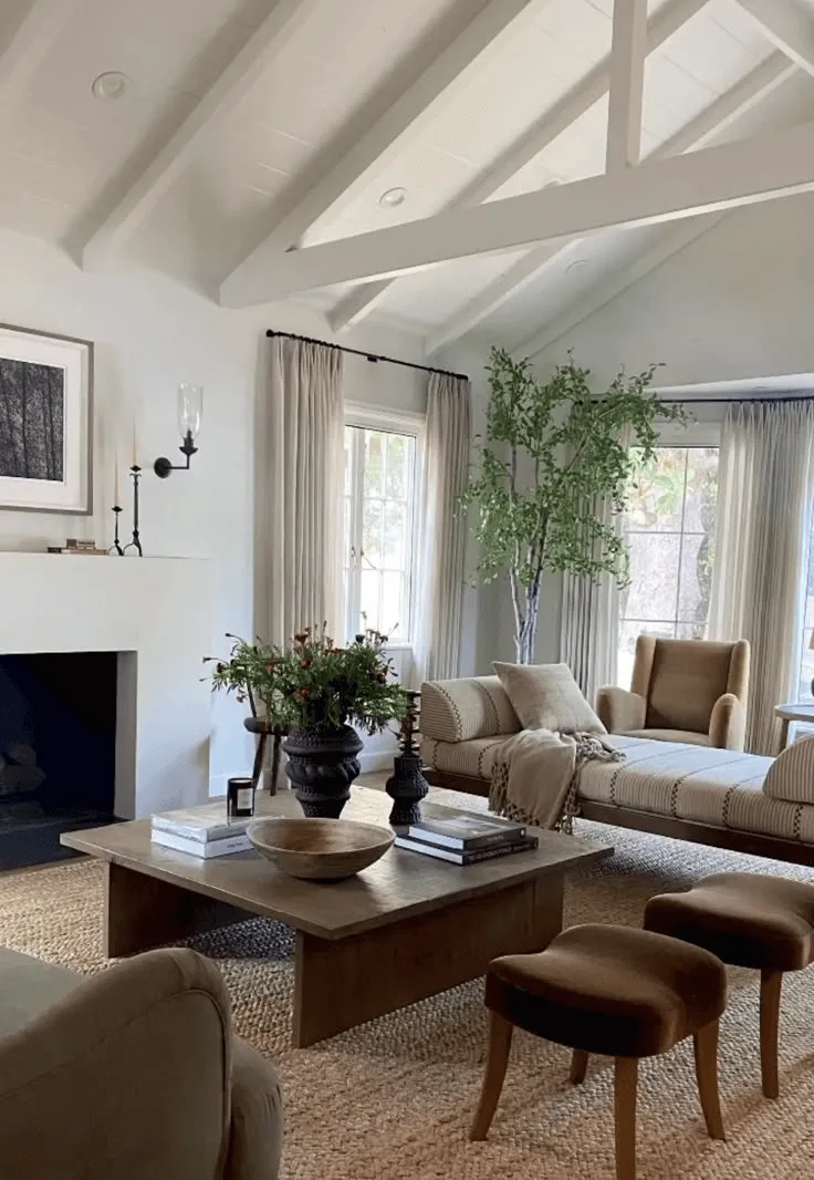 a Spanish-style home's living room with fireplace and white ceiling beams