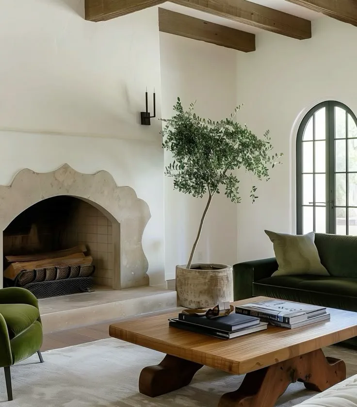 a Spanish-style plaster and stone fireplace in living room interior with furniture and decor