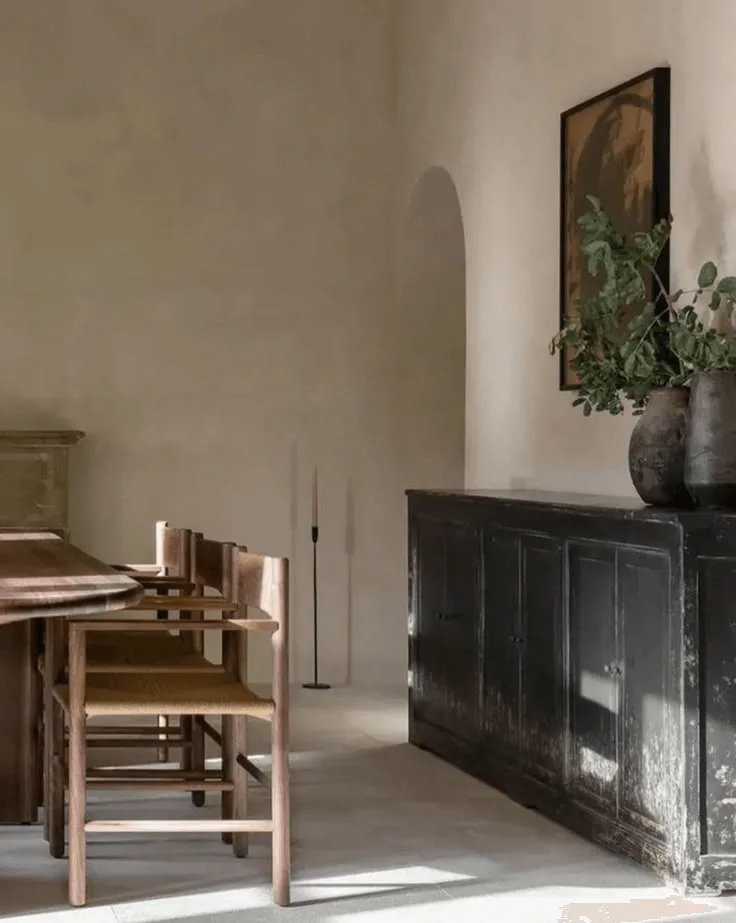 a modern Spanish-Colonial style house interior showing a dining room with leather chairs