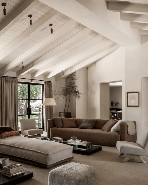 a large living room interior with white plank ceiling and couch, modern furniture and decor in neutral colors 