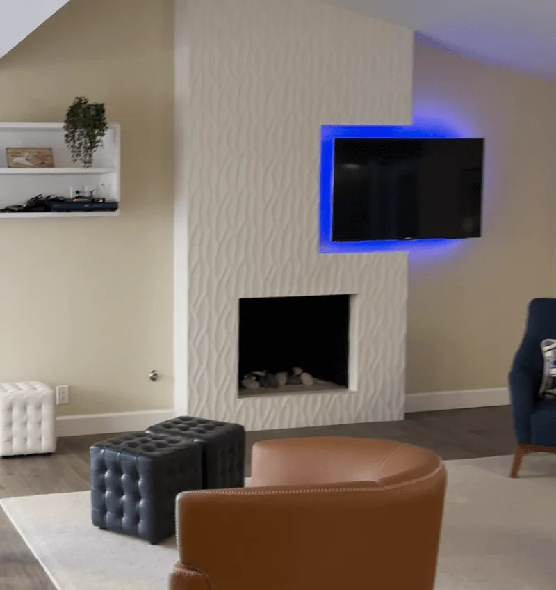a tile fireplace remodeled with TV in a neutral living room