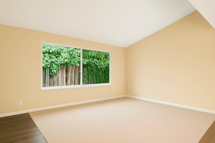 a living room with a big empty wall showing large blank wall ideas