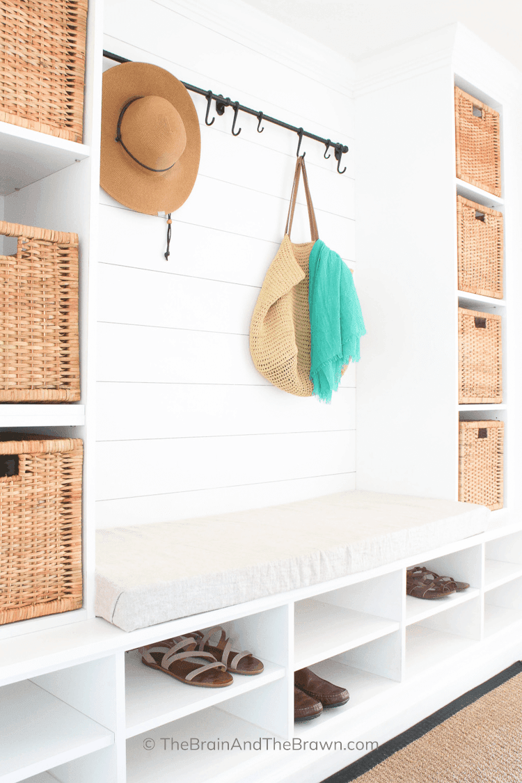 a white laundry room bench storage