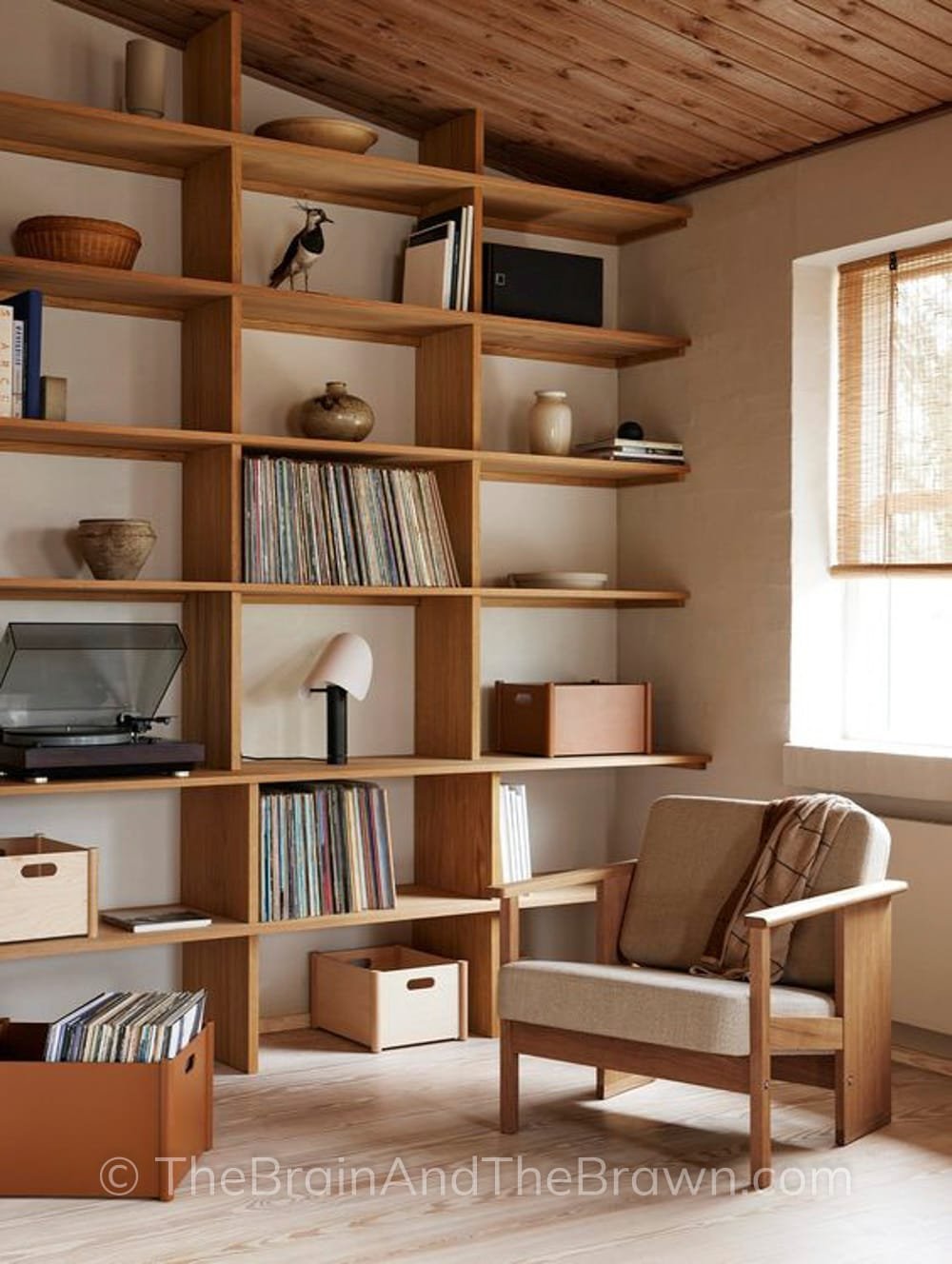 a creative open book shelving unit in a living room showing how to decorate a blank wall in a modern way