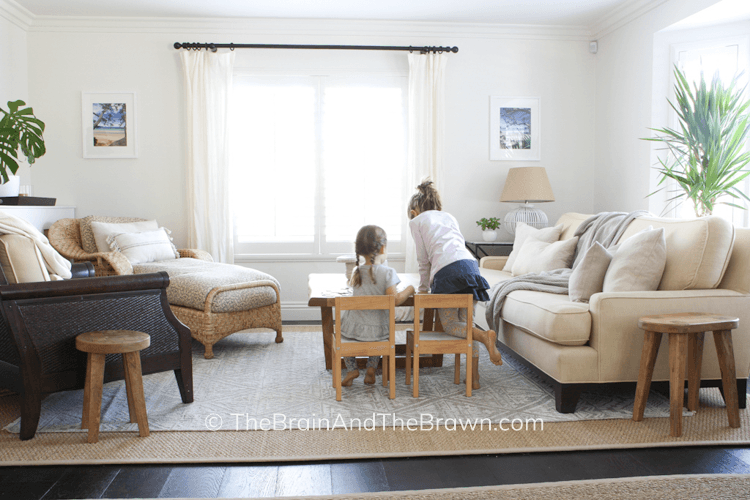 a small living room arrangement with sofa, chaise, and chairs with a puzzle area