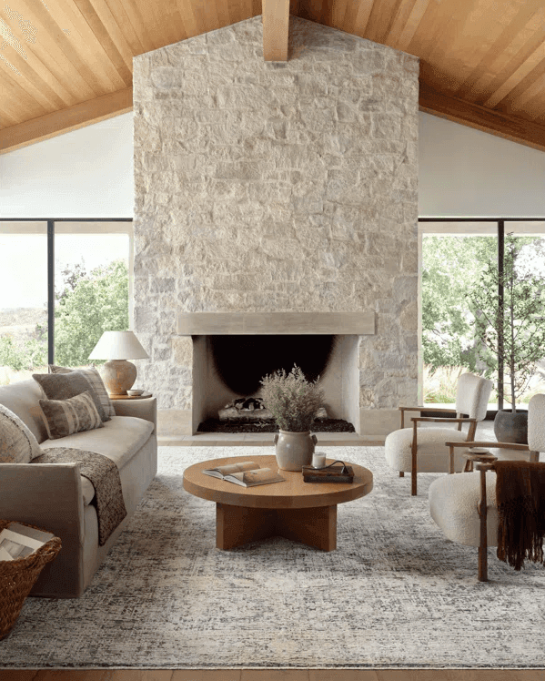 grey stone fireplace in living room, modern transitional with wood ceilings 