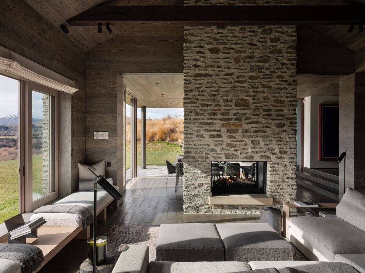 dark stacked stone fireplace idea in living room