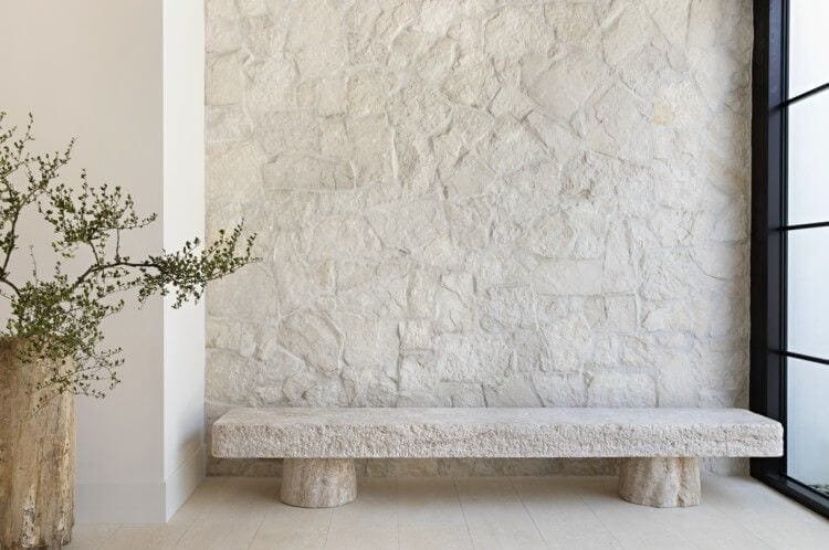 A neutral stone veneer idea with a stone bench below