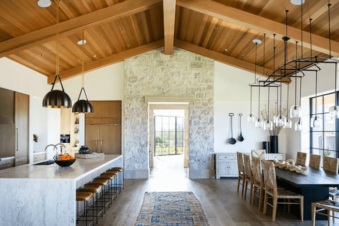A modern kitchen and dining with stone door walkway