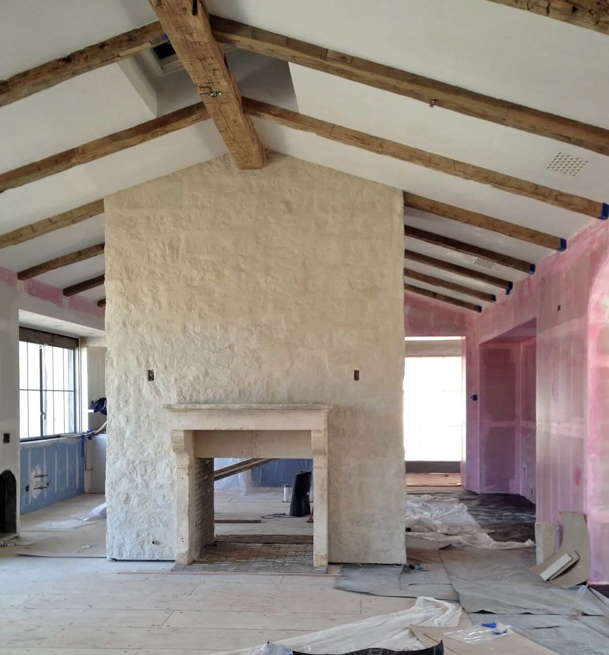 a tall room with high ceilings and stone fireplace idea with stone surround