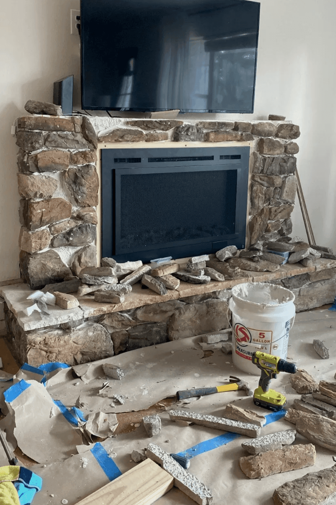 a before and after of a stone veneer fireplace being put together